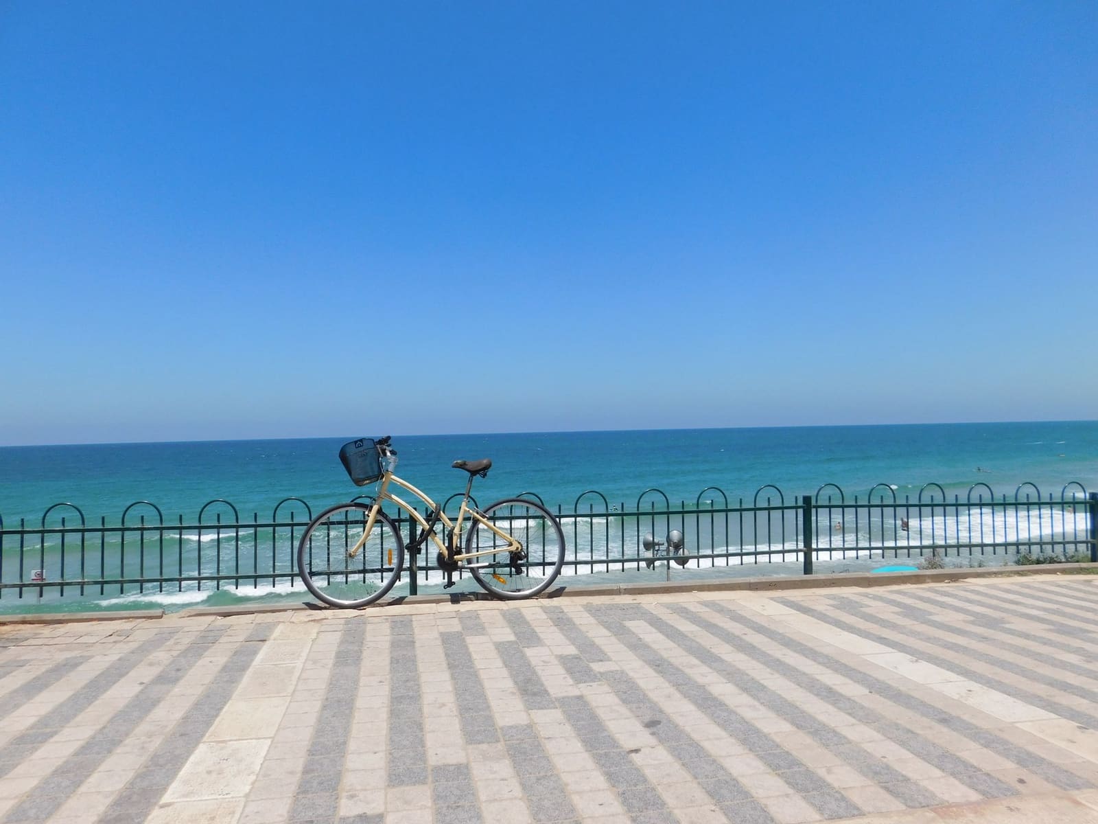 A bicycle parked on the seafront promenade