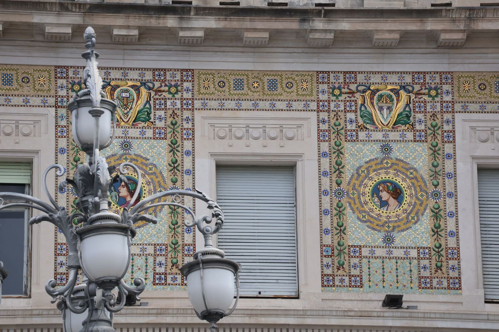 Façade with ceramic tiles and an old street lamp