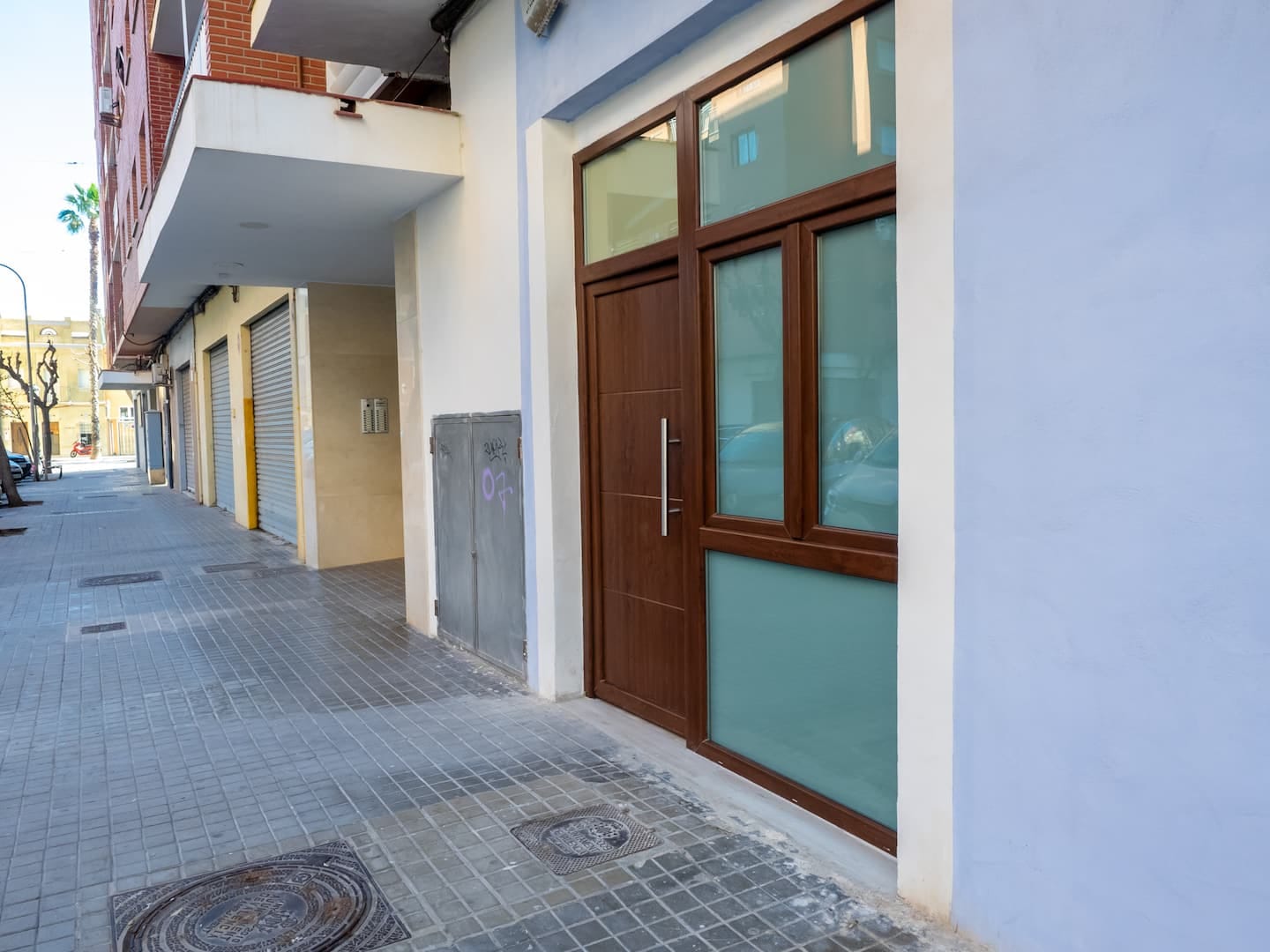 The studios' street, with its wooden doors and blue façade